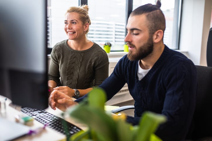 male and female colleagues at computer