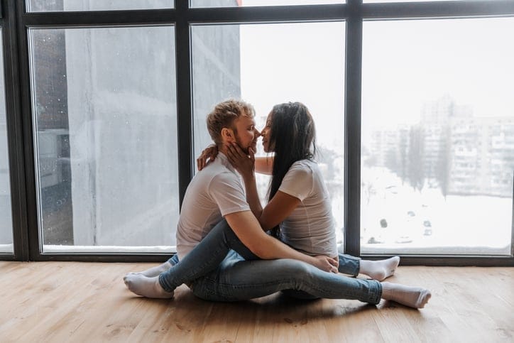 couple in romantic embrace on floor