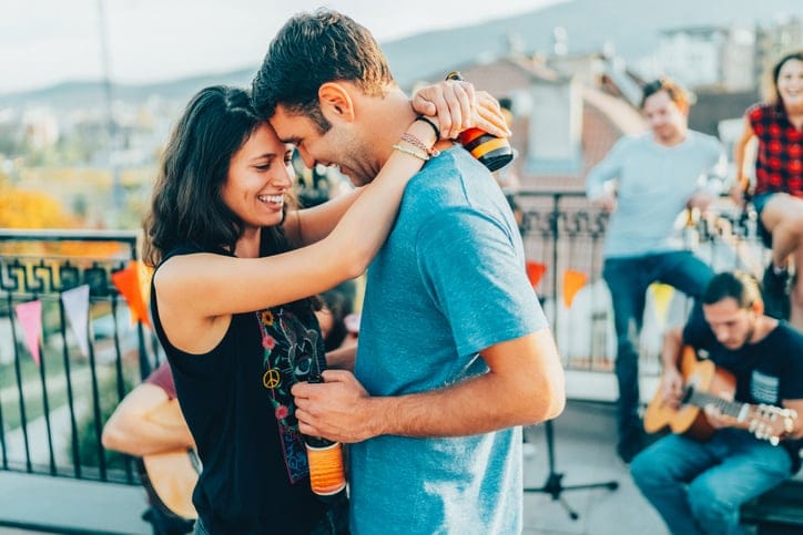 couple embracing at rooftop party