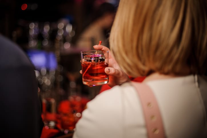 woman with drink in hand