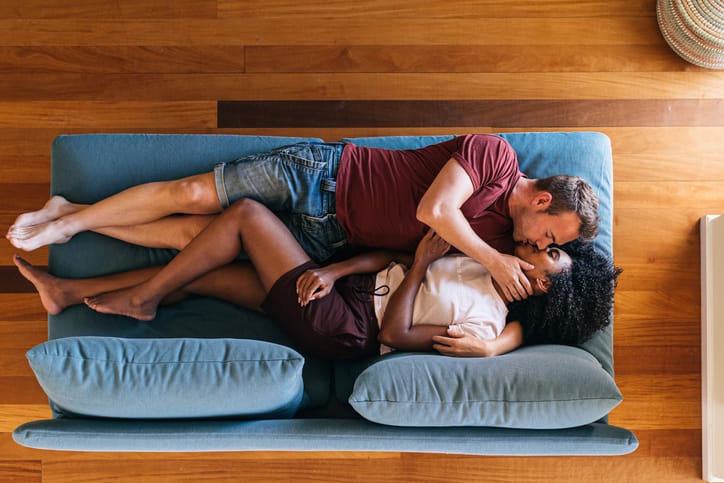 couple kissing lying on couch
