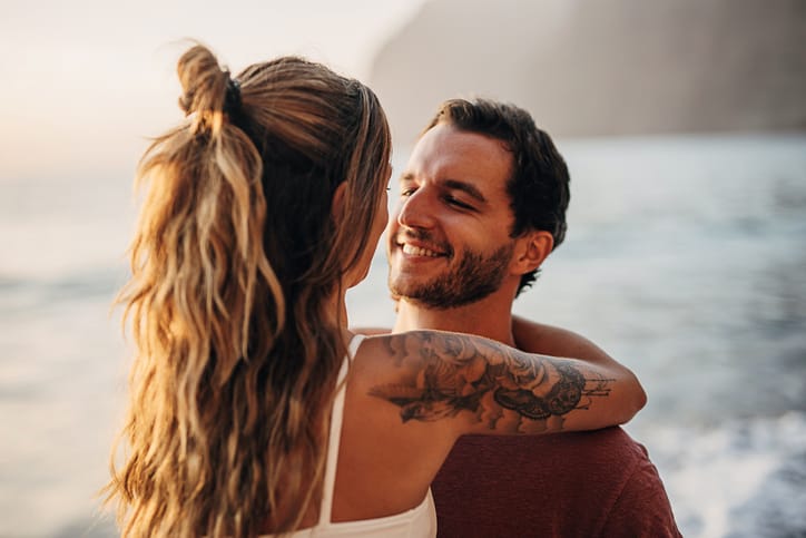 romantic couple kissing on the beach