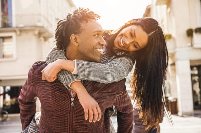 happy couple embracing in sunshine