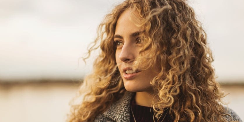 woman looking to side at beach