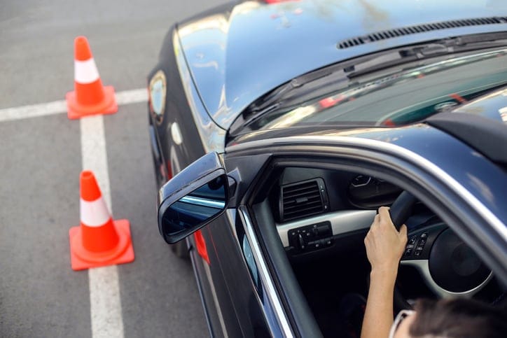 Young woman learning how to drive a car. About 20 years old, Caucasian female.