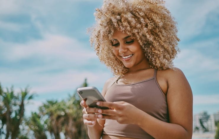 Young woman using a phone in the city.