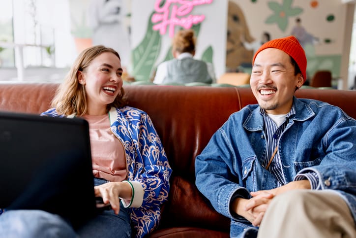 Friends chatting on a couch.