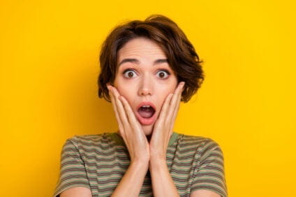 Woman with her hands on her face exasperated.