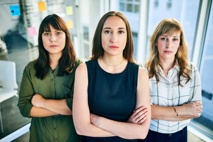 three women arms crossed