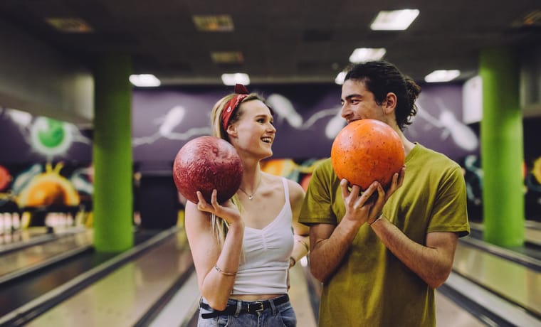 young couple on a date bowling