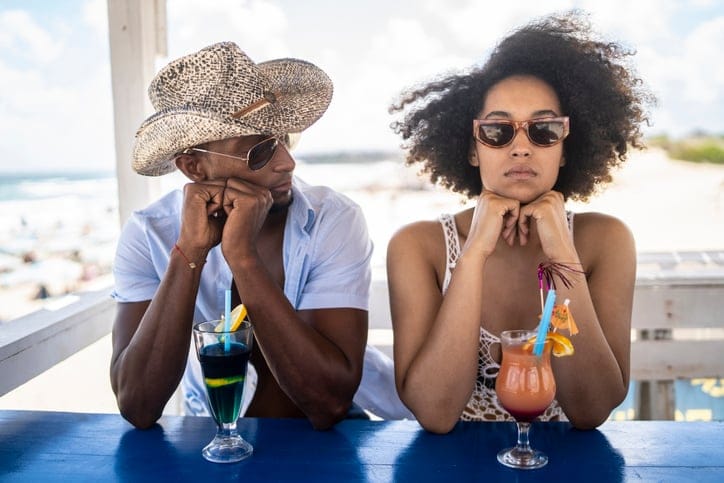 angry woman at beach with boyfriend