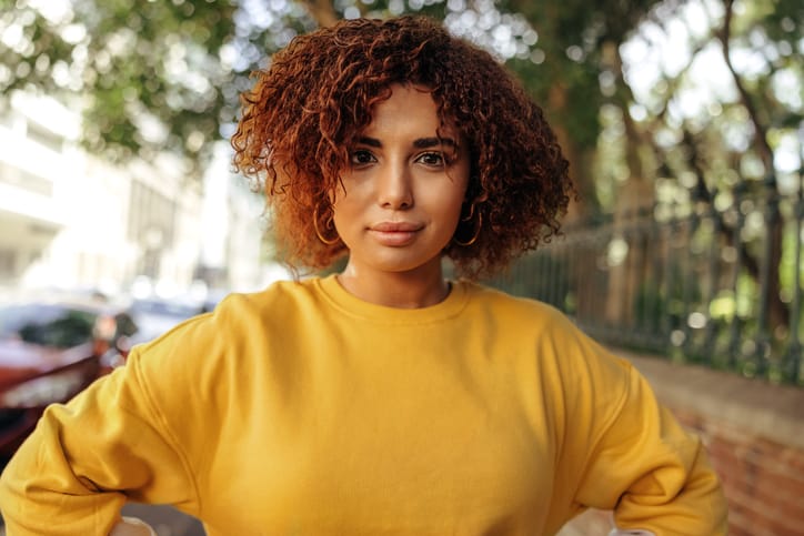 Self-confident woman standing with her hands on her hips.