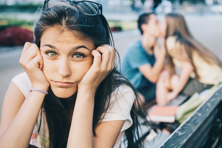 Woman confused by couple behind her.
