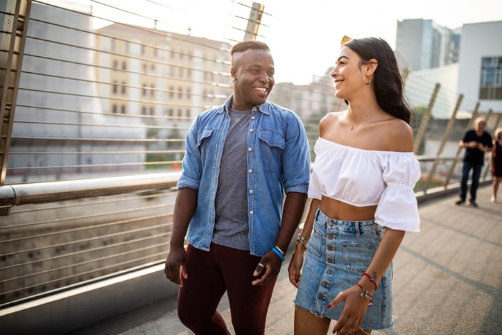 couple walking hand in hand outdoors