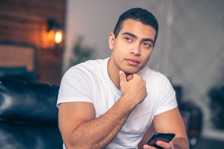 black man holding smartphone