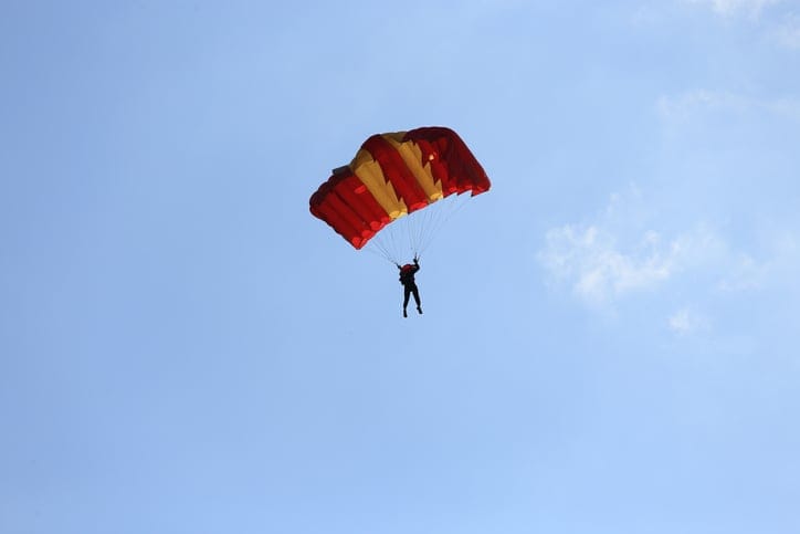 Parasailing in blue skies.