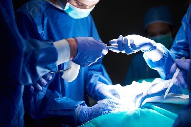 Surgeons passing instruments in the hospital during an operation.