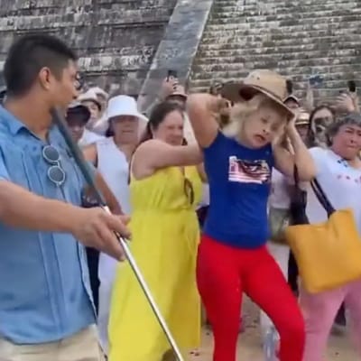 tourist climbs mayan temple
