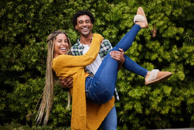 happy Black couple smiling outside