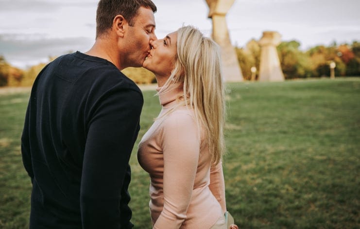 happy couple kissing outdoors