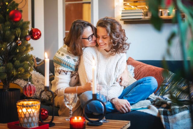 lesbian couple cuddling at christmas