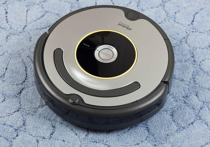 iRobot vacuum on rug.