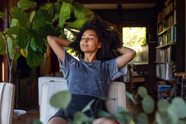 woman relaxing with eyes closed at home