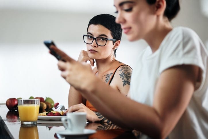 Female friends chatting in the kitchen.