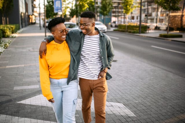 happy couple walking through city