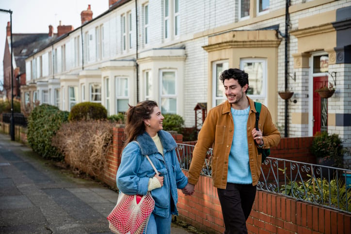 couple holding hands walking
