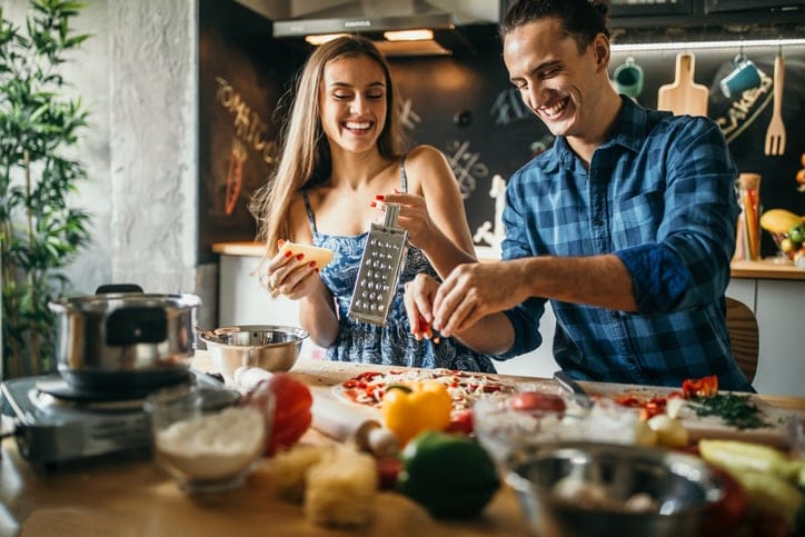 Young couple cooking together.