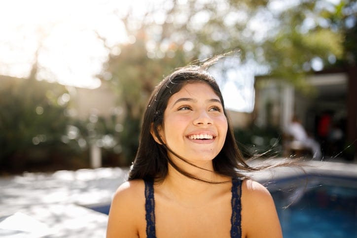 smiling brunette girl in sunshine