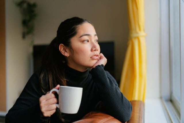 sad woman looking out window