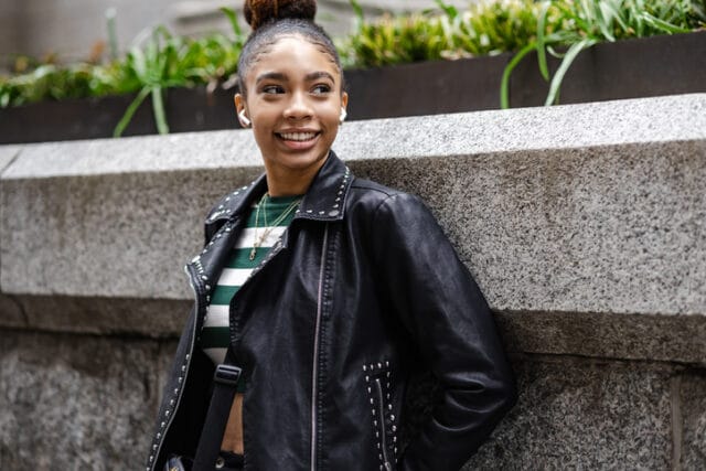 smiling young black woman with airpods