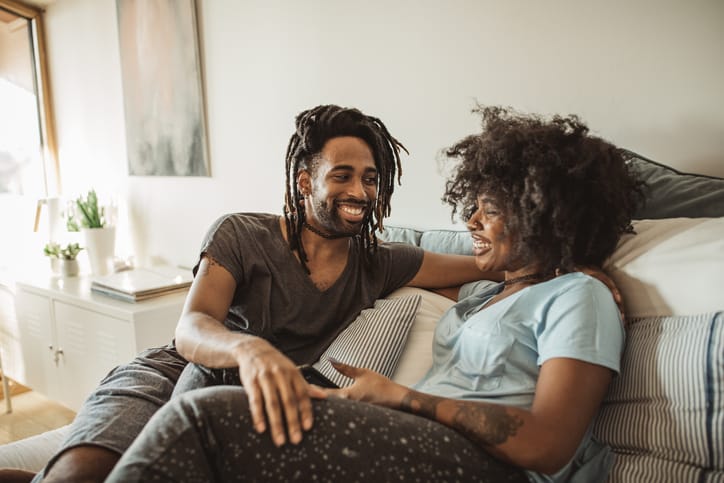 Couple chatting on the couch.