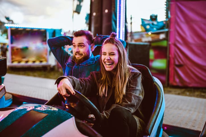 couple having fun on bumper cars