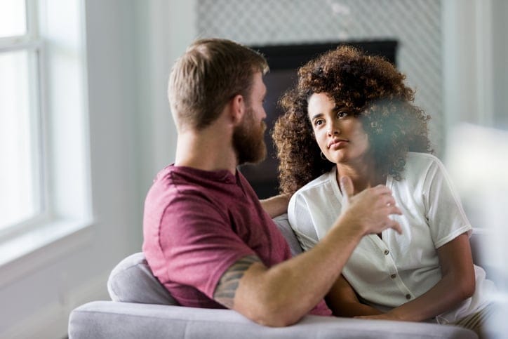 couple chatting at home on couch
