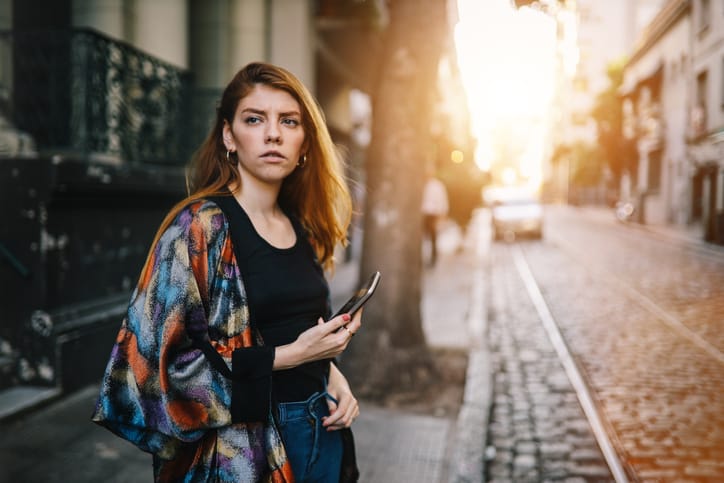 woman with cellphone on city streets
