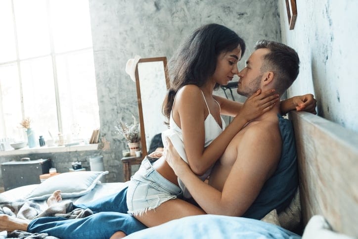 woman straddling man in bed