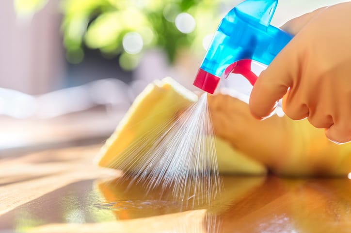 Cleaning counter with spray cleaner.