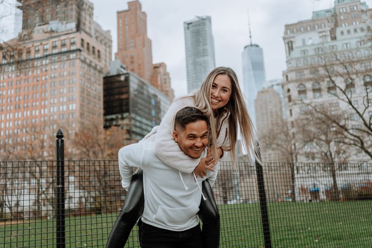 woman piggybacking on boyfriend in new york