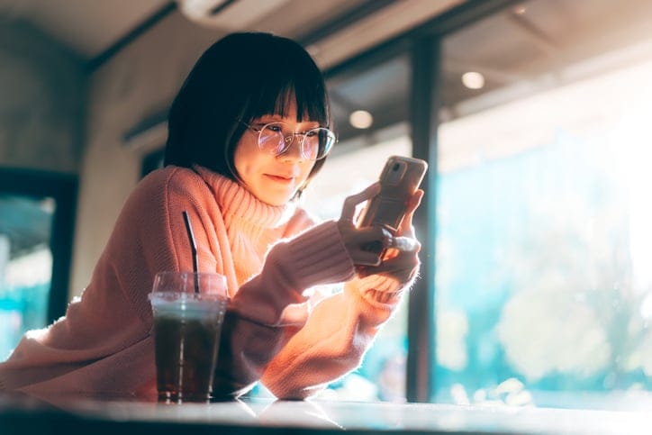 young korean woman texting