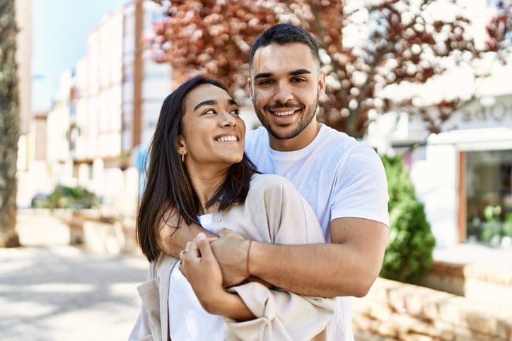 couple embracing on sunny street