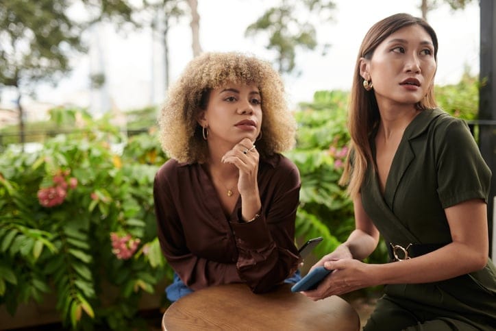 two friends having a chat outside