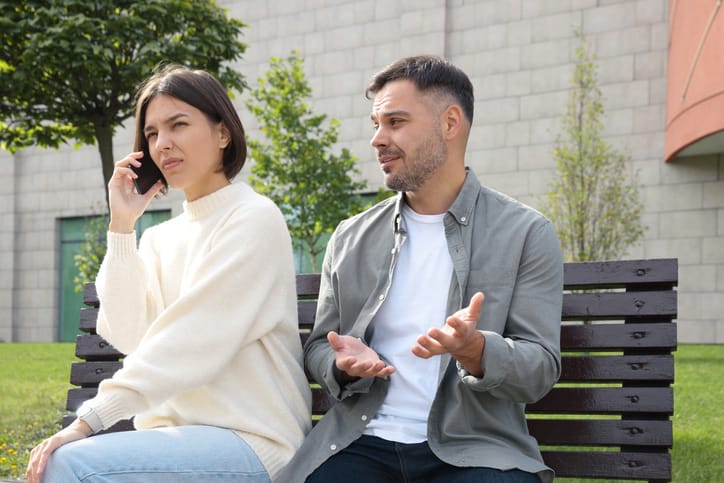 Woman ignoring her boyfriend and talking on phone.