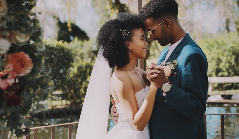 Romantic couple kissing at their wedding.