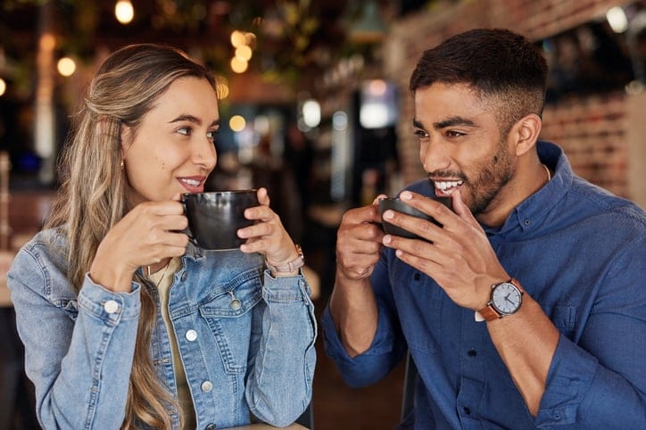Couple on smiling coffee date.