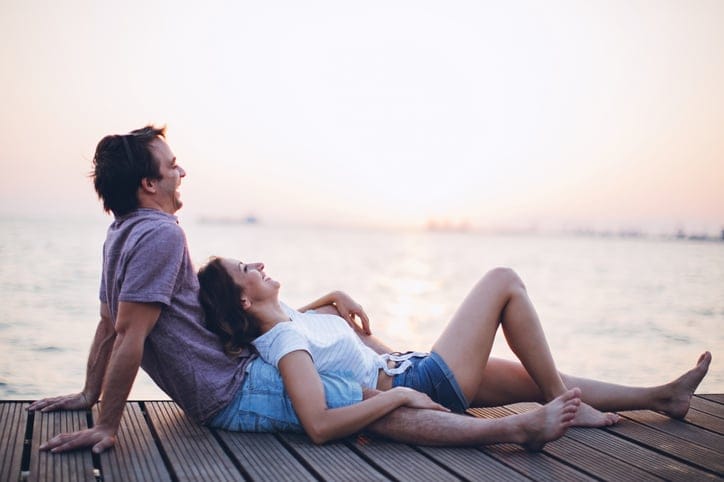 couple lounging on pier