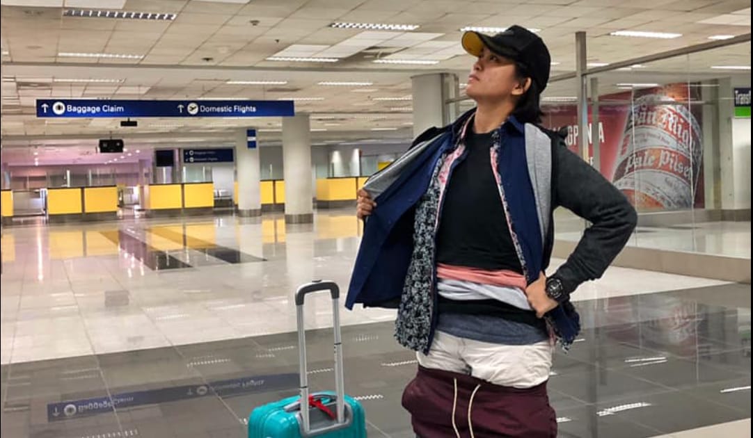 Woman at the airport baggage carousel.