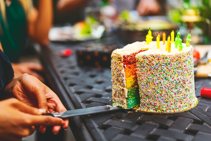 cake being sliced and served
